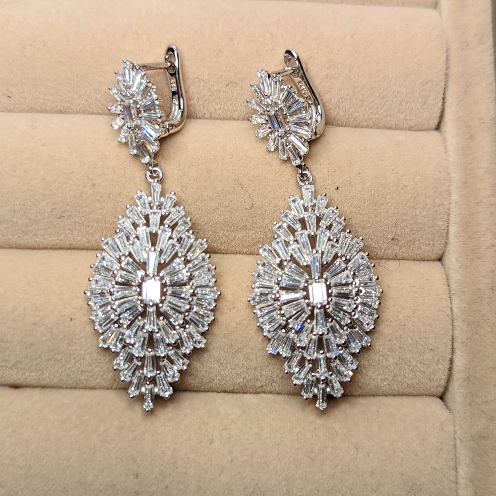 Baguette cut cubic zirconia and rhodium plated sterling silver earrings.